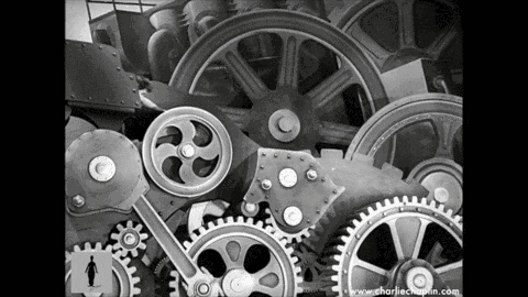 Charlie Chaplin swallowed by the cogs of a machine in Modern Times